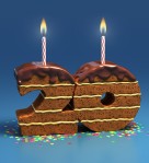 Picture of chocolate cake in the shape of the number 20 with two candles on top